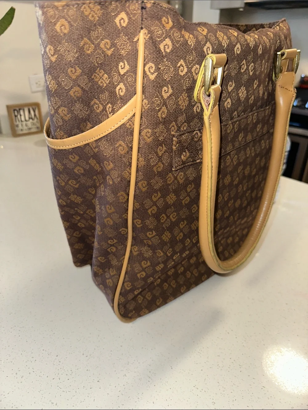 This is a brown Pierre Cardin monogram logo tote bag with beige leather handles.